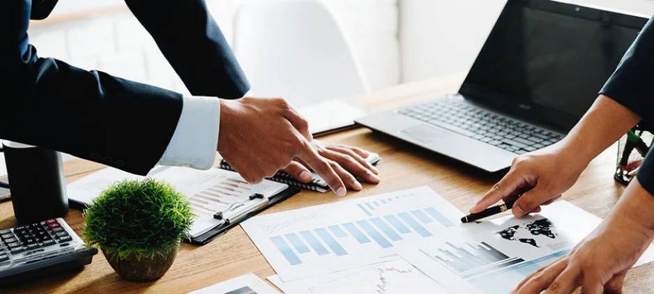 Handing pointing at financial chart